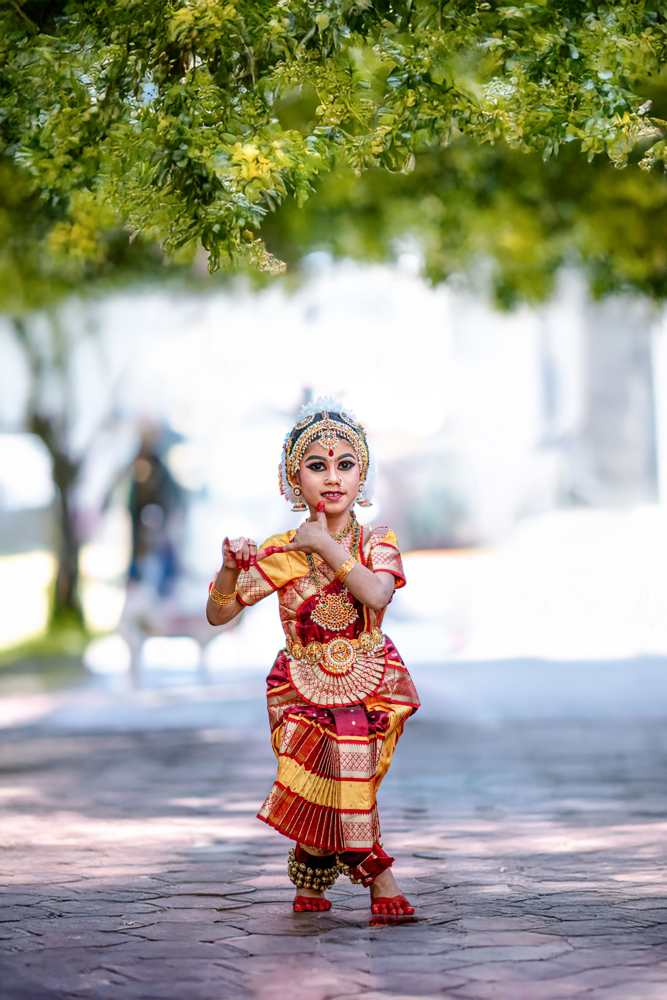 Young Indian child performing classical dance in traditional costume